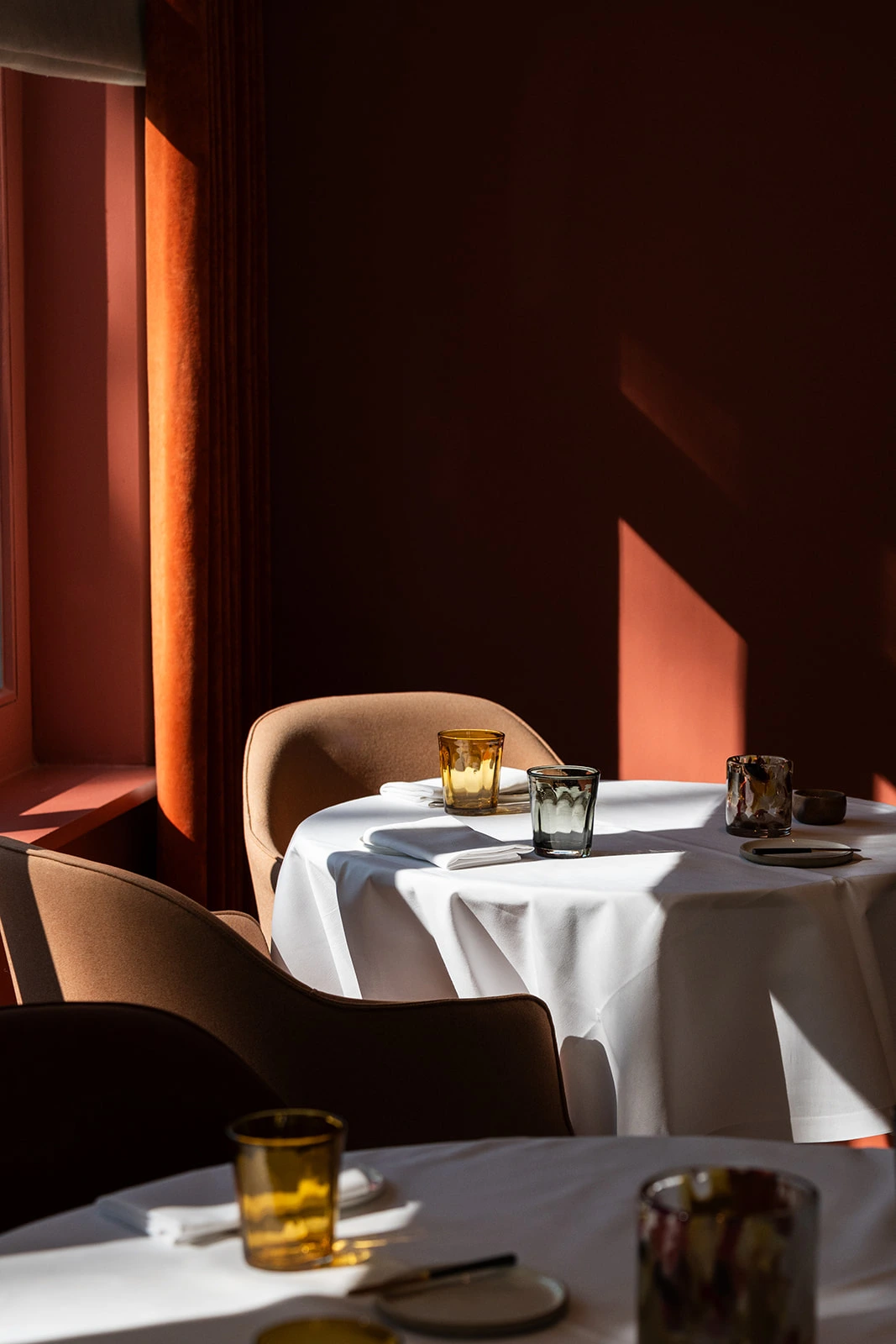 Tables set for the holidays in the warm red room at Brabohoeve